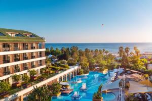 an aerial view of a resort with a pool and the ocean at TUl BLUE Side Adult Only 16 Plus - Ultra All Inclusive in Side