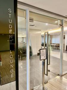 a sign in front of a glass door in a building at JC Condo, SMDC Green Malate Taft Manila in Manila