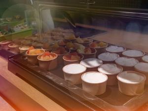 a tray of muffins in cups on a table at Ibis Budget Le Havre Les Docks in Le Havre