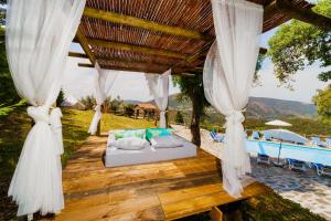 uma cama num deque de madeira junto a uma piscina em Cabana Sobreiro em Castelo de Paiva