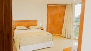Tempat tidur dalam kamar di Mako´s Hotel