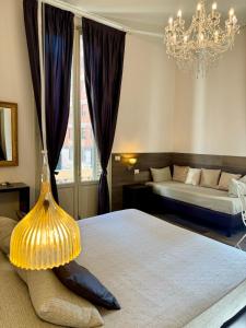 a bedroom with two beds and a chandelier at Maglo Station in Bologna