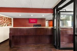 a lobby with a bar with a red sign on the wall at Red Roof Inn Springfield, IL in Springfield