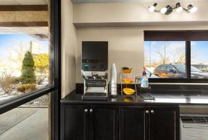 a kitchen with a counter with a coffee maker at Red Roof Inn Springfield, IL in Springfield