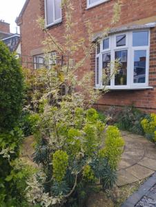 a garden in front of a brick house at Offa Home in Leamington Spa