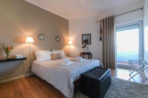 a bedroom with a bed and a large window at Apartment Sol Mar in Ponta Delgada