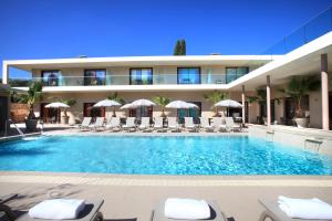 a swimming pool in front of a hotel at Seventeen Hotel in Valbonne