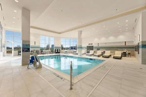 a large swimming pool in a large building at Embassy Suites By Hilton Irving Las Colinas in Irving