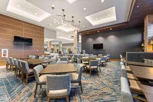 a large dining room with tables and chairs at Embassy Suites By Hilton Irving Las Colinas in Irving