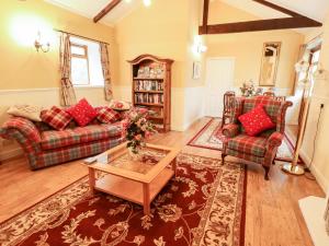 a living room with two couches and a coffee table at The Barn in Snitterby