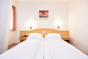 En eller flere senger på et rom på Central City Hotel Rochat
