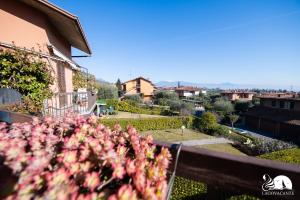 a view from the balcony of a house with pink flowers at Appartamento Giada in Padenghe sul Garda