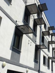 a building with balconies on the side of it at La Résidence Amal in Talence
