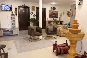 - un salon avec des chaises, un canapé et une télévision dans l'établissement Sejan hotel, à Aqaba