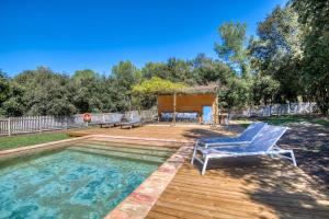 a pool with two lounge chairs and a gazebo at Mas Dalia - Turismo Rural - Girona - Monells, Empordà in Monells