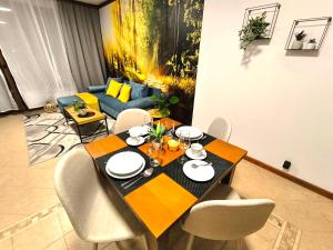 a dining table and chairs in a living room at 6 Luxury SPA Apartments TOP resort Bansko - incl wellness in Bansko