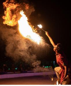 a person is holding up a pole with fire at Excellent Desert Safari camp in Sām