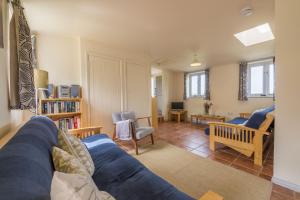 a living room with a blue couch and a chair at Hollyhock 