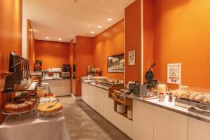 a bakery with a counter with many different types of pastries at Hotel White in Rome