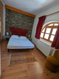 Un dormitorio con una cama y una pared de ladrillo. en Gîte Neige Cordier - Villar d'Arène center 2 bedrooms and large terrace, en Villar-dʼArène