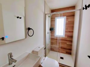 a bathroom with a shower with a toilet and a sink at Habitaciones Santiago in Puerto de Sagunto