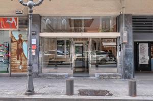 a store front with glass doors on a city street at Euskalduna Apartamento Moderno y Renovado in Bilbao