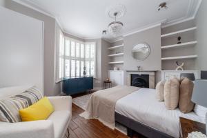 a bedroom with a bed and a fireplace at The Hammersmith Villa in London