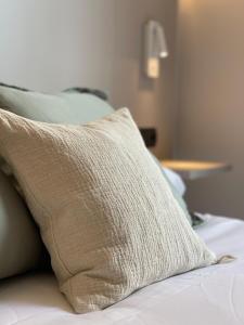 a pillow sitting on top of a bed at AZ Hotel San Valero in Zaragoza