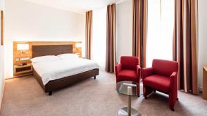 En eller flere senger på et rom på Central City Hotel Rochat