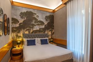 a bedroom with a large white bed with blue pillows at Hotel White in Rome