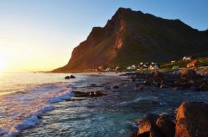 a view of a beach with a mountain in the background at Lofoten - Koselig leilighet for 3 personer. in Sund