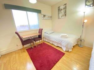 a room with a bed and a desk and a window at Single Room - Kings Cross, Female Only,, Guest House in London