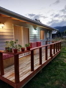 a deck with potted plants on a house at Cabañas Volcán Dormido, Hornopirén in Hornopiren
