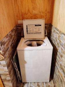 a washing machine with a box on top of it at Cabañas Volcán Dormido, Hornopirén in Hornopiren