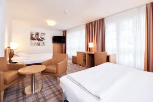 En eller flere senger på et rom på Central City Hotel Rochat