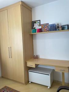 a room with a desk and a shelf and a desk at Quarto Morumbi - Somente Mulheres in Sao Paulo