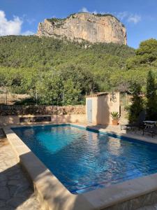 a swimming pool with a mountain in the background at Sa Sort de Can Moix in Alaró