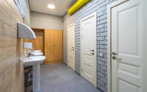 a bathroom with two sinks and a white door at ololoFreelander Hostel&Coworking in Bishkek