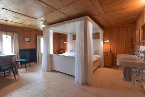 a bedroom with a bed and a sink in a room at Casa Fausta Capaul in Breil/Brigels