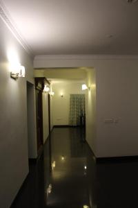 an empty room with a hallway with a hallway at ZIONS HOTEL AND APERTMENT in Devanhalli