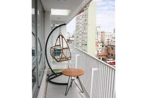 a chair on a balcony with a view of a city at BOLI0703 Comodidad y Estilo: Apt. para 3 en San Telmo in Buenos Aires