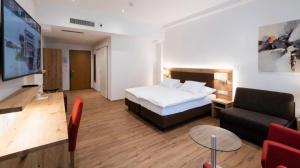 En eller flere senger på et rom på Central City Hotel Rochat