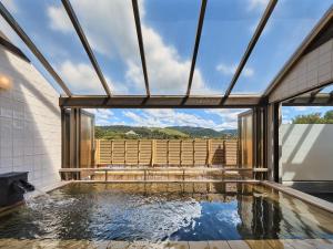 a swimming pool in a house with a large window at Wakasa Annex in Nara