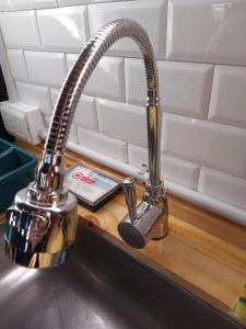 a kitchenaucet on a counter next to a sink at La Montañesa in Epuyén