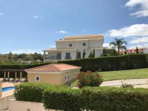 a large house with a swimming pool in front of it at TAC - Alcantarilha House in Alcantarilha