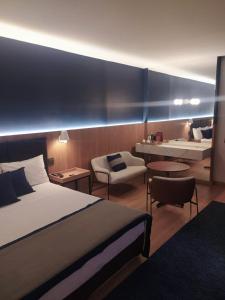 a hotel room with a bed and a living room at Transamerica Araraquara in Araraquara