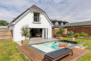 a backyard with a swimming pool and a house at Luxury, eco-friendly 3 bed haven with plunge pool - Riverway Retreat Lux in Christchurch