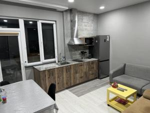 a kitchen with a couch and a table and a refrigerator at RS apartment in Batumi
