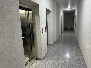 an empty hallway with a glass door in a building at RS apartment in Batumi