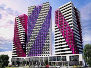 three tall buildings are painted pink and purple at RS apartment in Batumi